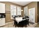 Bright dining room with large windows, white shutters, and a table with seating for six at 1027 Banks Rose St, Celebration, FL 34747