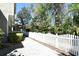 Exterior shot of a home with a white picket fence and meticulously landscaped yard at 1027 Banks Rose St, Celebration, FL 34747