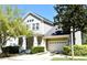 Charming two-story home with a front porch, attached garage, and manicured landscaping in a quiet residential neighborhood at 1027 Banks Rose St, Celebration, FL 34747