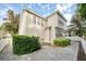 Charming two-story home exterior with manicured landscaping, brick paved driveway, and white picket fence at 1027 Banks Rose St, Celebration, FL 34747