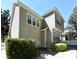 Exterior view of home with light beige siding, white trim, and manicured landscaping at 1027 Banks Rose St, Celebration, FL 34747