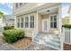 Home exterior with brick driveway, white fence, and stairs leading to the front door at 1027 Banks Rose St, Celebration, FL 34747