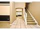This entryway showcases a tiled foyer, staircase, and view into a living room through an arched doorway at 1027 Banks Rose St, Celebration, FL 34747