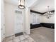 Elegant foyer with tile flooring and stylish black and white accent wall at 1027 Banks Rose St, Celebration, FL 34747
