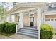 Charming front porch with white columns and a well-manicured garden at 1027 Banks Rose St, Celebration, FL 34747