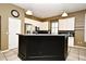 A kitchen features white cabinets, dark countertops, and stainless steel appliances at 1027 Banks Rose St, Celebration, FL 34747