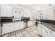 White kitchen with stainless steel appliances, dark countertops, and tile flooring at 1027 Banks Rose St, Celebration, FL 34747