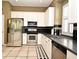 Bright kitchen features stainless steel appliances, white cabinets, and black backsplash at 1027 Banks Rose St, Celebration, FL 34747