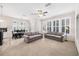 Open-concept living room featuring neutral paint, carpet, and multiple windows with plantation shutters at 1027 Banks Rose St, Celebration, FL 34747