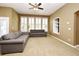 Inviting living room with neutral walls, large windows and plush seating at 1027 Banks Rose St, Celebration, FL 34747