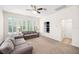 Bright living room with built-in shelves, neutral walls, carpeting, and plantation shutters at 1027 Banks Rose St, Celebration, FL 34747