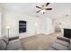 Spacious living room with carpeting, built-in shelves, and easy access to stairs and other rooms at 1027 Banks Rose St, Celebration, FL 34747