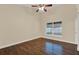 A bright bedroom with a large window, neutral walls, and hardwood floors at 1049 Summer Lakes Dr, Orlando, FL 32835