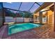 Inviting screened-in pool area with a pristine pool, brick patio, and seamless access to the home's interior at 1049 Summer Lakes Dr, Orlando, FL 32835