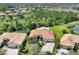 An aerial shot of a beautiful home with a red roof, mature landscaping, and an attached two car garage at 1233 Cambria Bnd, Kissimmee, FL 34759