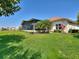 The lush backyard features verdant grass, colorful flowers and tropical shrubbery, giving a private oasis feel at 1233 Cambria Bnd, Kissimmee, FL 34759