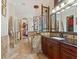 Bathroom featuring a large vanity, a garden tub, and a separate walk-in closet at 1233 Cambria Bnd, Kissimmee, FL 34759