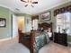 Bedroom with a large bed, neutral carpet, a window with shutters, and crown molding at 1233 Cambria Bnd, Kissimmee, FL 34759