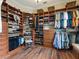 Spacious walk-in closet with custom shelving, drawers, and ample hanging space at 1233 Cambria Bnd, Kissimmee, FL 34759