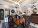 Formal dining room boasts beautiful wood table, ornate chairs, chandelier and opens up into the living room at 1233 Cambria Bnd, Kissimmee, FL 34759