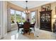 Formal dining area with elegant chandelier, large windows, and tile flooring at 1233 Cambria Bnd, Kissimmee, FL 34759