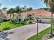 Beautiful single-story home featuring a well-manicured lawn and driveway with large palm trees, and a tile roof at 1233 Cambria Bnd, Kissimmee, FL 34759