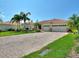 Beautiful single-story home with a well-manicured lawn, an American flag, and a spacious driveway at 1233 Cambria Bnd, Kissimmee, FL 34759