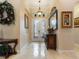 Elegant foyer features marble flooring, decorative mirrors and artwork, and ornate lighting creating a grand entrance at 1233 Cambria Bnd, Kissimmee, FL 34759