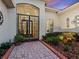 Charming front entrance featuring a decorative security door and beautiful landscaping at 1233 Cambria Bnd, Kissimmee, FL 34759