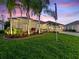 Beautiful home with well-manicured lawn, palm trees, and side entry garages at 1233 Cambria Bnd, Kissimmee, FL 34759