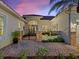 Stately home with brick driveway, decorative gate, and lush landscaping at 1233 Cambria Bnd, Kissimmee, FL 34759