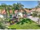 Charming single-Gathering home boasts a beautifully manicured front yard with lush green grass and mature palm trees at 1233 Cambria Bnd, Kissimmee, FL 34759