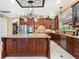 Spacious kitchen features a center island, stainless steel appliances, custom cabinets, and tiled backsplash at 1233 Cambria Bnd, Kissimmee, FL 34759