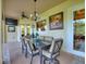 Enjoy the lanai, which features a table, chairs, chandelier, and ceiling fan, and plenty of room to relax or dine at 1233 Cambria Bnd, Kissimmee, FL 34759