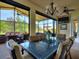 Relax and unwind in the lanai's dining area with a ceiling fan and great views of the yard and the golf course at 1233 Cambria Bnd, Kissimmee, FL 34759