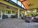Spacious lanai featuring ample seating, dining area, and ceiling fans, perfect for indoor-outdoor living at 1233 Cambria Bnd, Kissimmee, FL 34759