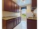 Well-equipped laundry room with cabinets, granite counters, sink and plenty of light at 1233 Cambria Bnd, Kissimmee, FL 34759