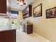 Functional laundry room with ample storage, granite countertops, and window at 1233 Cambria Bnd, Kissimmee, FL 34759