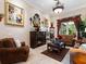 Comfortable living room features a fireplace, stylish furniture, and large windows overlooking the backyard at 1233 Cambria Bnd, Kissimmee, FL 34759