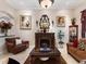 Comfortable living room features a fireplace, stylish furniture, and large windows overlooking the backyard at 1233 Cambria Bnd, Kissimmee, FL 34759
