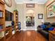 Home office features a comfortable leather sofa and opens to the formal dining room with backyard view at 1233 Cambria Bnd, Kissimmee, FL 34759