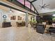 Large covered patio featuring lots of ceiling fans, and a view of the dining area and seating area at 1233 Cambria Bnd, Kissimmee, FL 34759