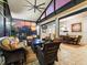 Large covered patio with ample seating, dining area, and stunning sunset views visible through the windows at 1233 Cambria Bnd, Kissimmee, FL 34759
