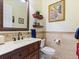 Cozy powder room with framed mirror, decorative shelves, and tile accents at 1233 Cambria Bnd, Kissimmee, FL 34759