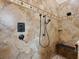 Close-up of the tiled shower with multiple shower heads and a built-in bench at 1233 Cambria Bnd, Kissimmee, FL 34759