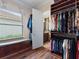 Bright walk-in closet with custom wood shelving and a window seat, adding luxury and organization to the space at 1233 Cambria Bnd, Kissimmee, FL 34759