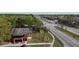 Aerial view of home next to main thoroughfare with mature trees and lush landscape at 1240 Sago Palm Blvd # 1240, Kissimmee, FL 34741