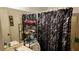 Bathroom featuring vanity and shower with black patterned curtain at 1240 Sago Palm Blvd # 1240, Kissimmee, FL 34741
