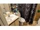 Bathroom featuring a vanity sink, toilet, and shower with a patterned curtain at 1240 Sago Palm Blvd # 1240, Kissimmee, FL 34741