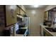 Efficient kitchen layout with white appliances and tile flooring providing space for everyday cooking needs at 1240 Sago Palm Blvd # 1240, Kissimmee, FL 34741